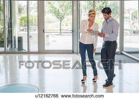 Business people talking in lobby View Large Photo Image Stock Photograph - Business people talking in lobby. Fotosearch