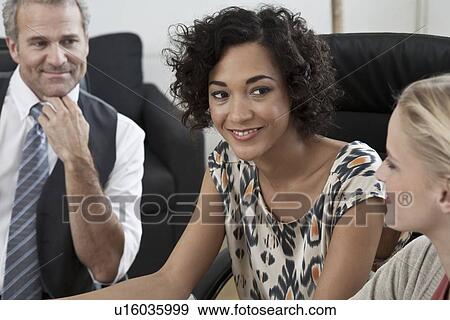 Stock Photo - Business people talking in office. Fotosearch