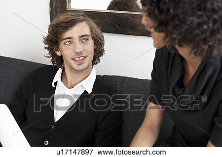 Stock Photo - Business people talking on sofa. Fotosearch