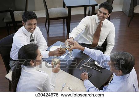 Stock Photograph - Business people toasting each other. Fotosearch