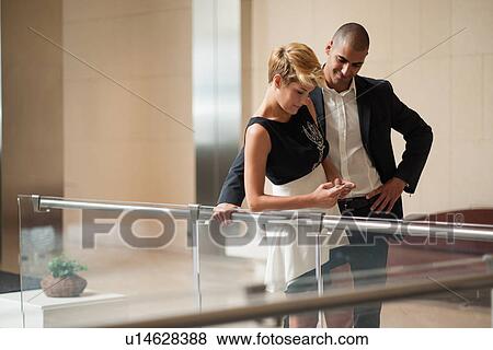 Business people using cell phone View Large Photo Image Stock Photo - Business people using cell phone. Fotosearch