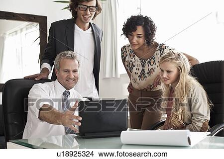 Business people using laptop at desk View Large Photo Image Picture - Business people using laptop at desk. Fotosearch