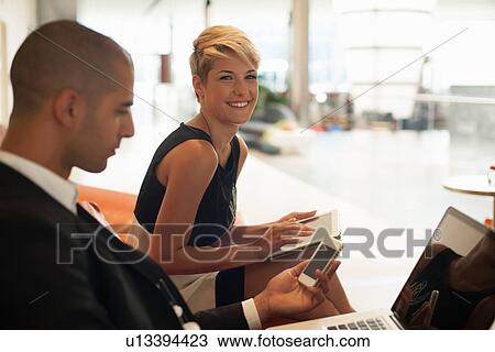 Stock Image - Business people using technology. Fotosearch