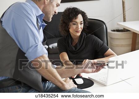 Business people working together at desk View Large Photo Image Picture - Business people working together at desk. Fotosearch