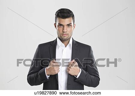 Businessman adjusting his suit View Large Photo Image Stock Image - Businessman adjusting his suit. Fotosearch