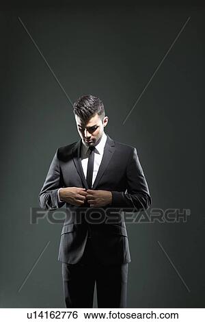 Businessman buttoning suit jacket View Large Photo Image Stock Photograph - Businessman buttoning suit jacket. Fotosearch