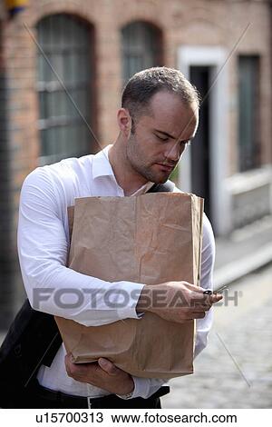Businessman carrying paper bag View Large Photo Image Stock Image - Businessman carrying paper bag. Fotosearch