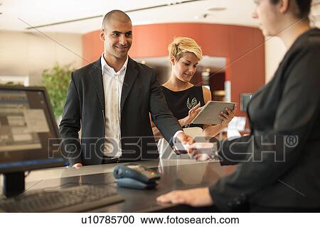 Businessman checking into hotel View Large Photo Image Stock Image - Businessman checking into hotel. Fotosearch