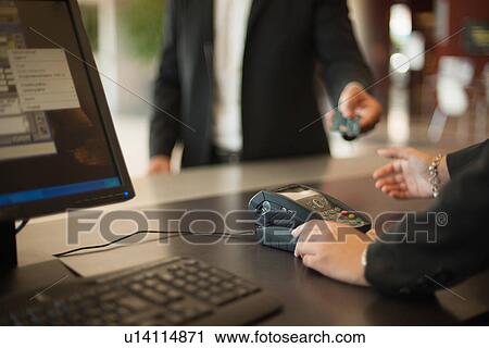 Businessman checking into hotel View Large Photo Image Stock Image - Businessman checking into hotel. Fotosearch