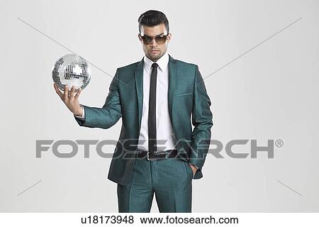Businessman holding disco ball View Large Photo Image Stock Photo - Businessman holding disco ball. Fotosearch