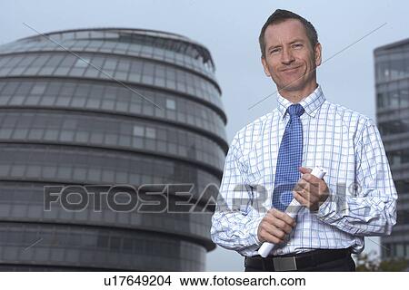 Businessman holding roll of paper View Large Photo Image Picture - Businessman holding roll of paper. Fotosearch