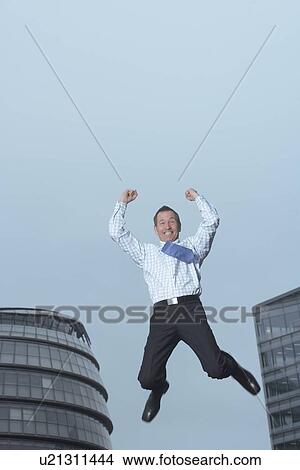 Businessman jumping for joy outdoors View Large Photo Image Picture - Businessman jumping for joy outdoors. Fotosearch