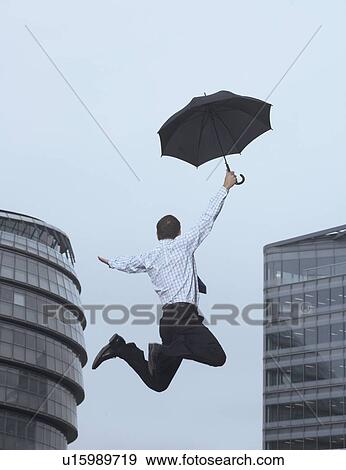 Stock Photo - Businessman jumping for joy outdoors. Fotosearch
