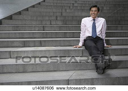 Businessman listening to headphones View Large Photo Image Stock Photograph - Businessman listening to headphones. Fotosearch