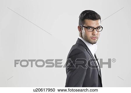 Businessman looking over his shoulder View Large Photo Image Stock Image - Businessman looking over his shoulder. Fotosearch