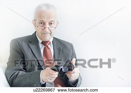 Stock Photo - Businessman playing video games. Fotosearch