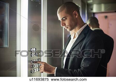 Businessman pressing elevator button View Large Photo Image Stock Photography - Businessman pressing elevator button. Fotosearch