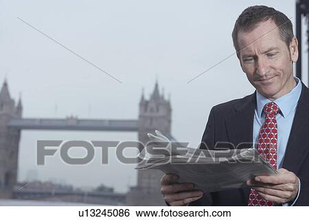 Businessman reading newspaper View Large Photo Image Stock Photograph - Businessman reading newspaper. Fotosearch