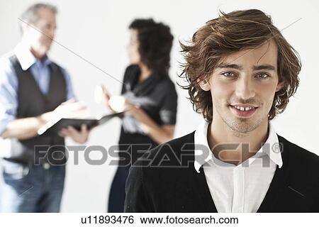 Stock Photograph - Businessman smiling in office. Fotosearch