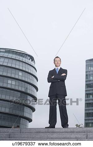 Businessman standing on urban steps View Large Photo Image Stock Photo - Businessman standing on urban steps. Fotosearch