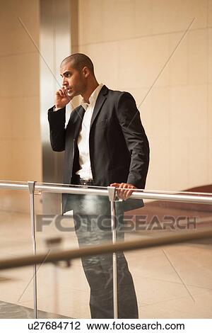Stock Image - Businessman talking on cell phone. Fotosearch