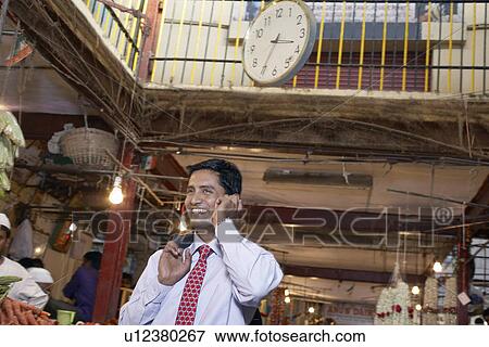 Stock Photo - Businessman talking on cell phone. Fotosearch