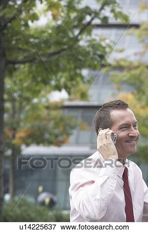 Businessman talking on cell phone View Large Photo Image Stock Photo - Businessman talking on cell phone. Fotosearch