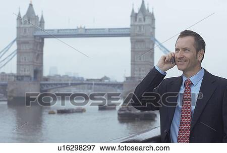 Stock Photo - Businessman talking on cell phone. Fotosearch