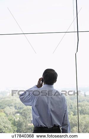 Stock Photo - Businessman talking on cell phone. Fotosearch
