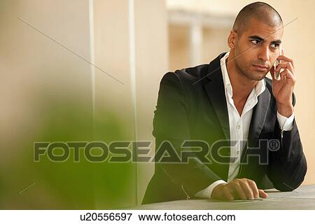 Businessman talking on cell phone View Large Photo Image Stock Photo - Businessman talking on cell phone. Fotosearch