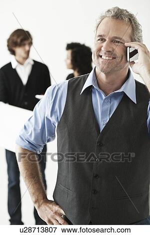 Businessman talking on cell phone View Large Photo Image Stock Photo - Businessman talking on cell phone. Fotosearch