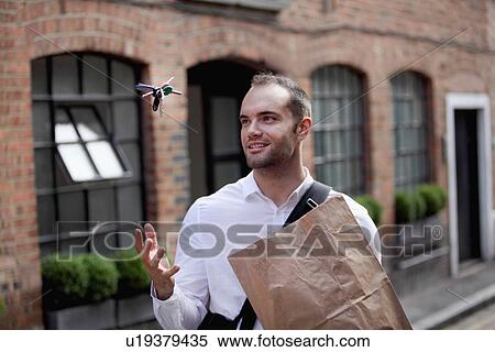 Stock Photography - Businessman tossing keys in air. Fotosearch