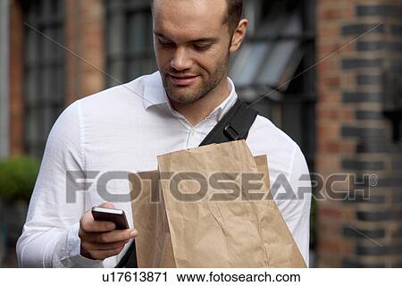 Businessman using cell phone outdoors View Large Photo Image Stock Image - Businessman using cell phone outdoors. Fotosearch