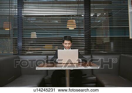 Businessman using laptop in cafe View Large Photo Image Stock Image - Businessman using laptop in cafe. Fotosearch