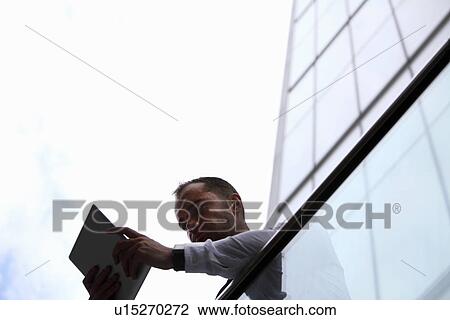 Businessman using tablet computer View Large Photo Image Stock Image - Businessman using tablet computer. Fotosearch