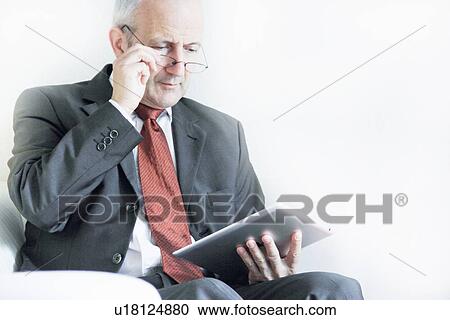 Stock Image - Businessman using tablet computer. Fotosearch