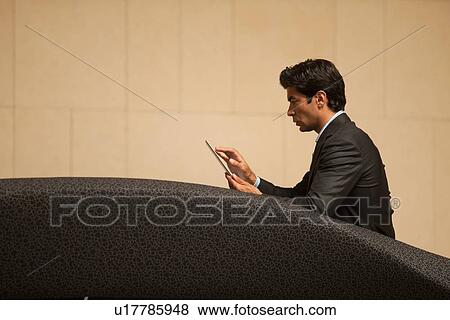 Businessman using tablet computer View Large Photo Image Stock Photo - Businessman using tablet computer. Fotosearch