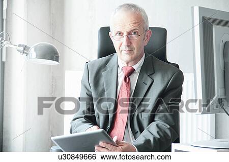 Stock Photograph - Businessman using tablet computer. Fotosearch