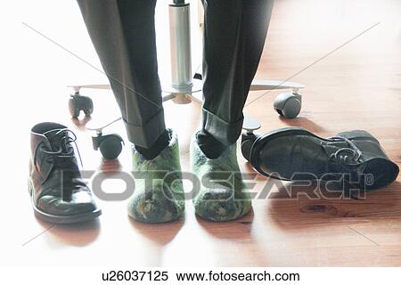 Businessman wearing slippers at desk View Large Photo Image Stock Photography - Businessman wearing slippers at desk. Fotosearch