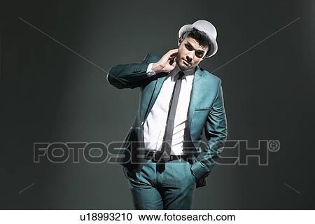 Stock Image - Businessman with hand in pocket. Fotosearch