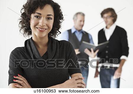 Stock Image - Businesswoman smiling in office. Fotosearch