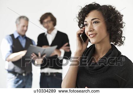 Stock Photo - Businesswoman talking on cell phone. Fotosearch