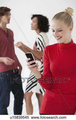 Businesswoman using cell phone in office View Large Photo Image Stock Photography - Businesswoman using cell phone in office. Fotosearch