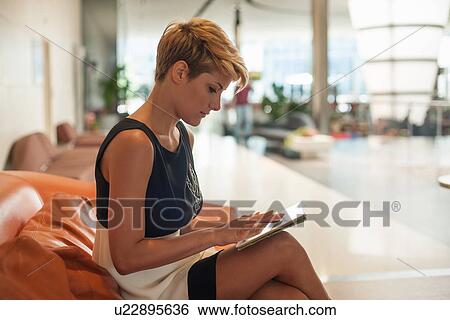 Stock Photograph - Businesswoman using tablet computer. Fotosearch