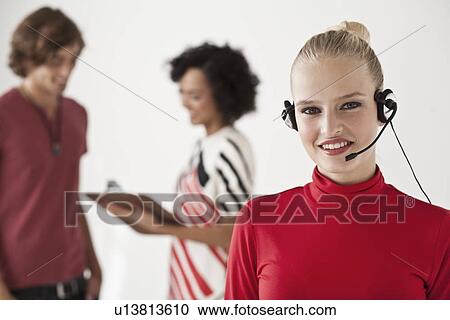 Businesswoman wearing headset in office View Large Photo Image Stock Image - Businesswoman wearing headset in office. Fotosearch