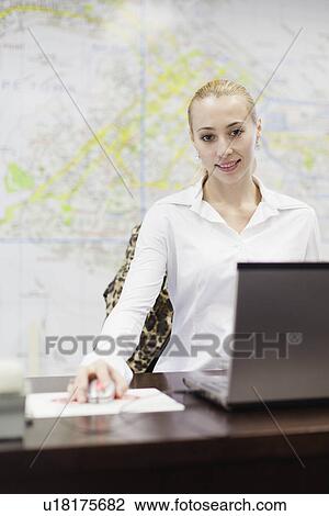 Businesswoman working at desk View Large Photo Image Stock Image - Businesswoman working at desk. Fotosearch