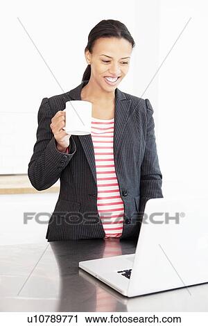 Businesswoman working with cup of coffee View Large Photo Image Stock Image - Businesswoman working with cup of coffee. Fotosearch