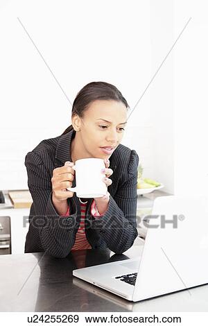 Stock Photo - Businesswoman working with cup of coffee. Fotosearch