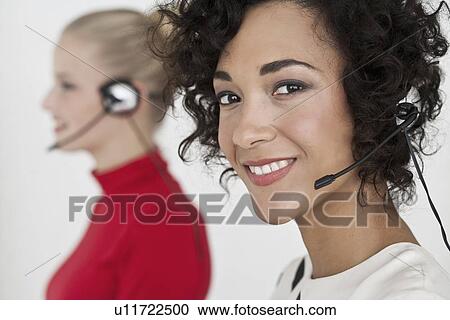 Businesswomen wearing headsets View Large Photo Image Stock Image - Businesswomen wearing headsets. Fotosearch