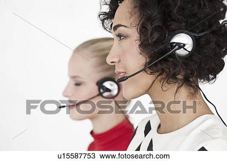 Businesswomen wearing headsets View Large Photo Image Stock Image - Businesswomen wearing headsets. Fotosearch